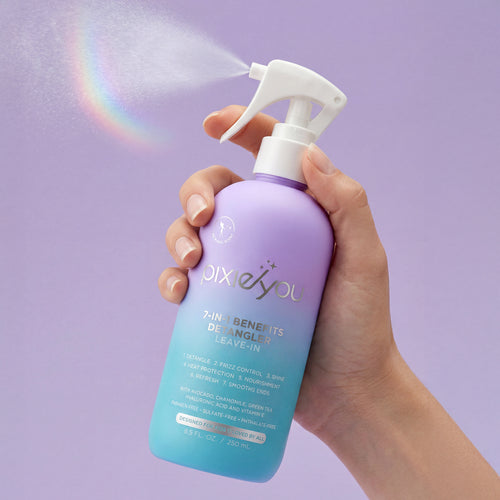 PixieYou 7-in-1 Benefits Detangler Leave-In Spray in a lavender bottle, being sprayed with a rainbow effect in the background