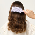 PixieYou Cloud Brush being used on wavy hair, showcasing its unique design and gentle detangling features.