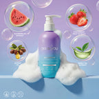PixieYou Shampoo bottle surrounded by watermelon, strawberry, jojoba oil, and green tea extracts with bubbles and foam.