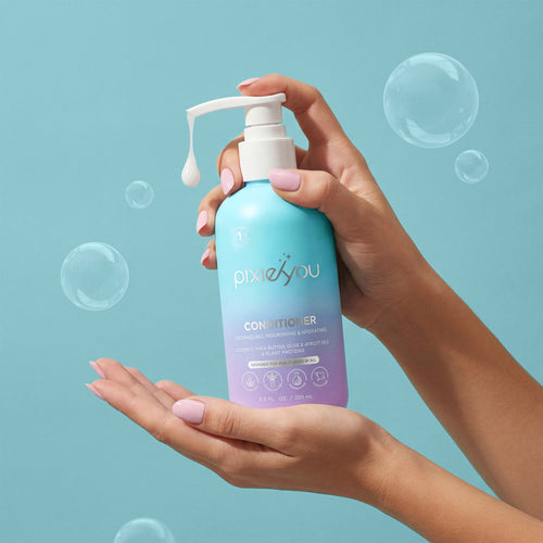 PixieYou Conditioner in a pump bottle held in a hand, with bubbles and a light blue background. 8.5 fl oz (250 ml).