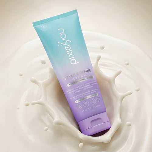 PixieYou Style & Define Leave-in Cream in a pastel tube, surrounded by a splash of creamy liquid. 8.5 fl oz.