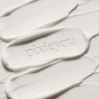 PixieYou Leave-in product displayed on a smooth, creamy white background with the brand name embossed.